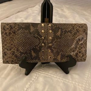 Studded snakeskin clutch.
